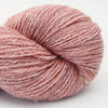 Ball of pink yarn on a white background