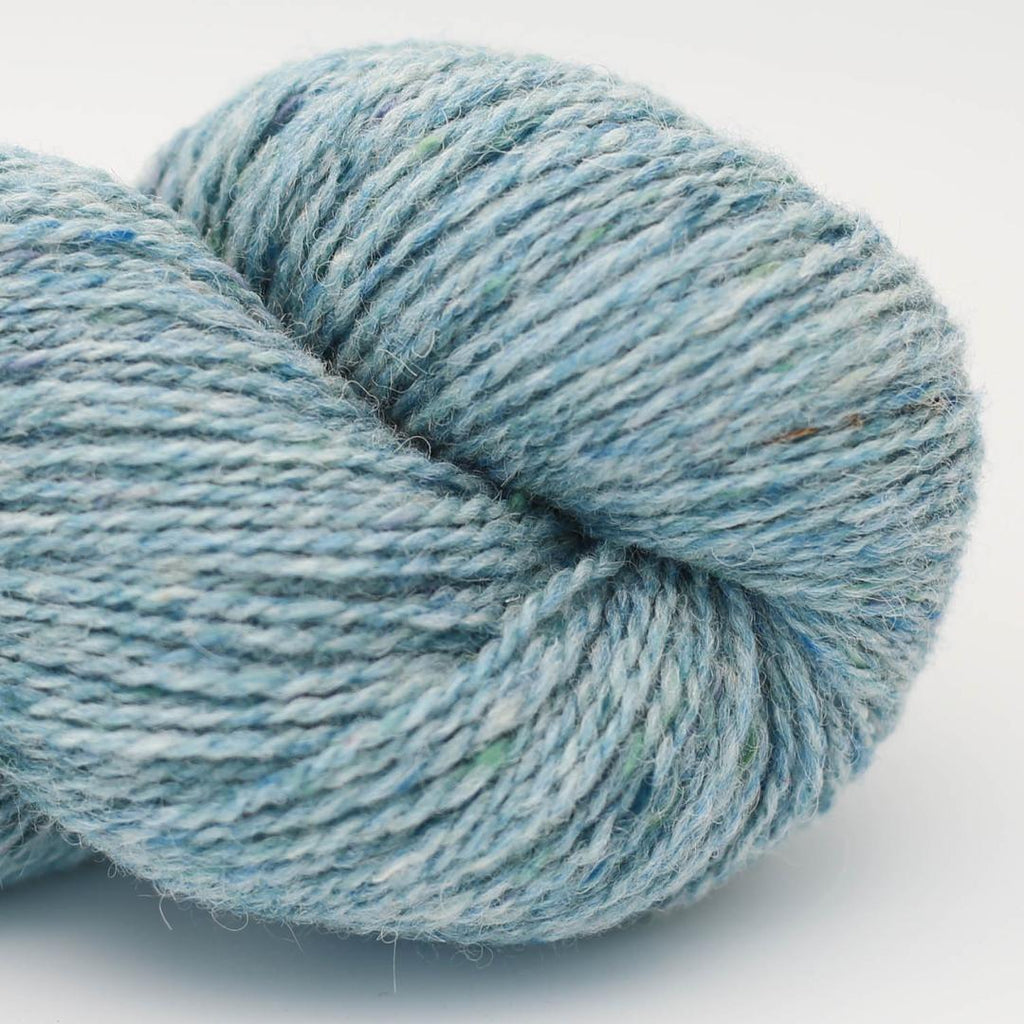 Blue skein of yarn on a white background