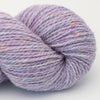 Purple skein of yarn with multicolor speckles on a light gray background