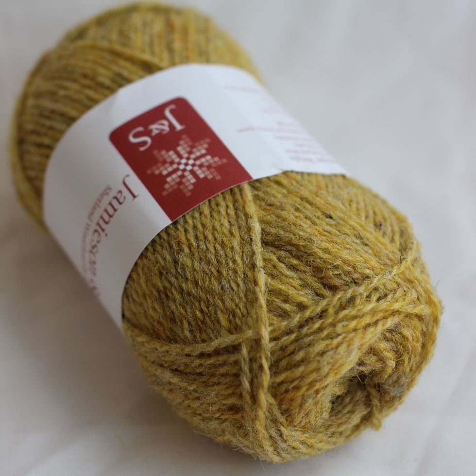 Ball of yellow yarn with a label on a white background