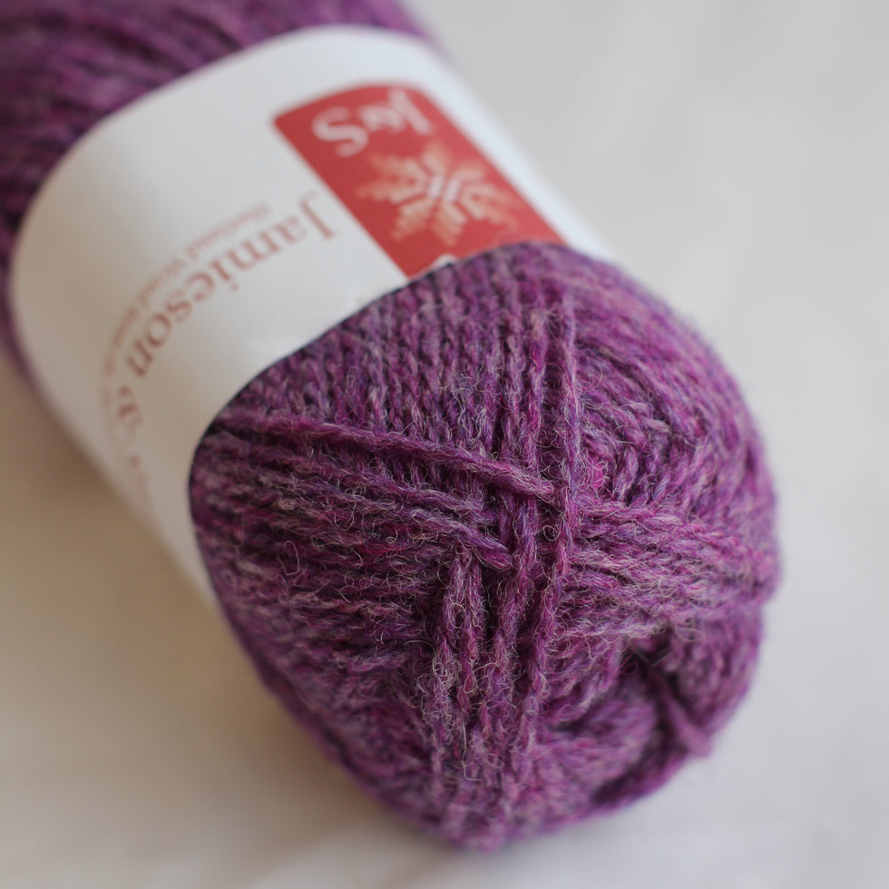 Purple yarn ball with a label on a light background