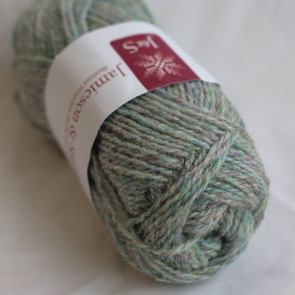 Ball of green yarn with a label on a white background