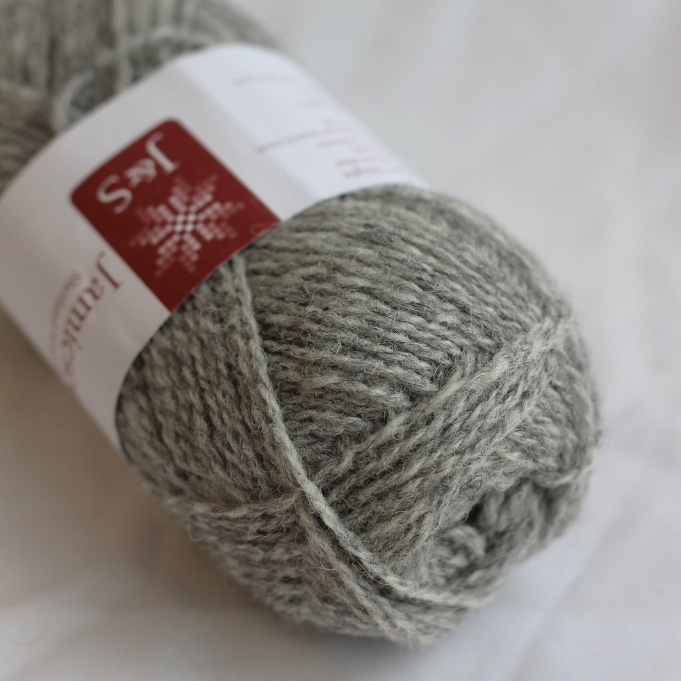 Gray skein of yarn with a label on a white background