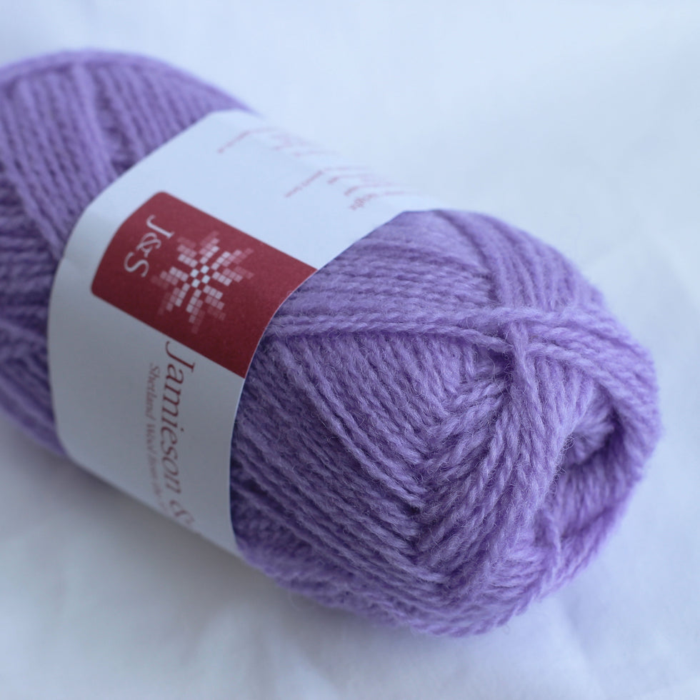 Purple yarn ball with a label on a white background