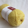 Yellow yarn ball with a label on a white background