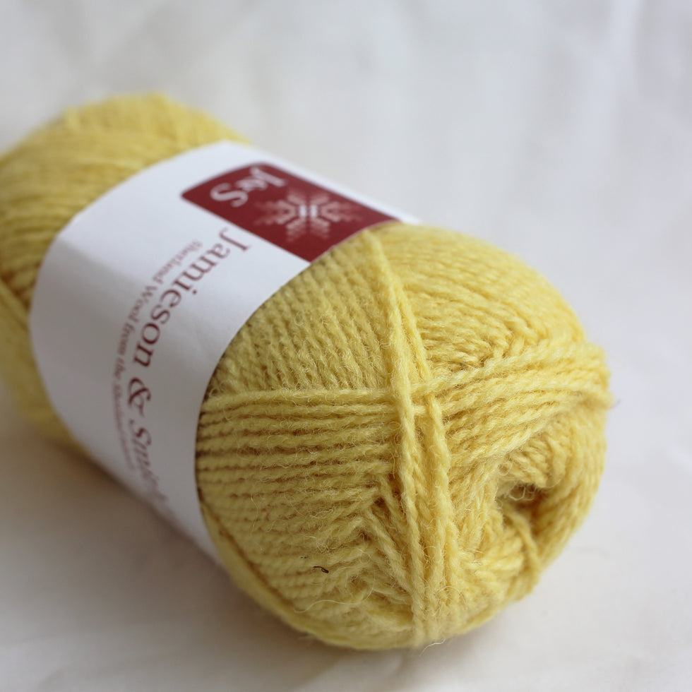 Yellow yarn ball with a label on a white background
