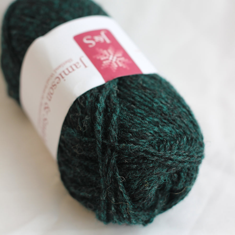 Green skein of yarn with a label on a white background