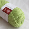 Light green skein of yarn with a label on a white background