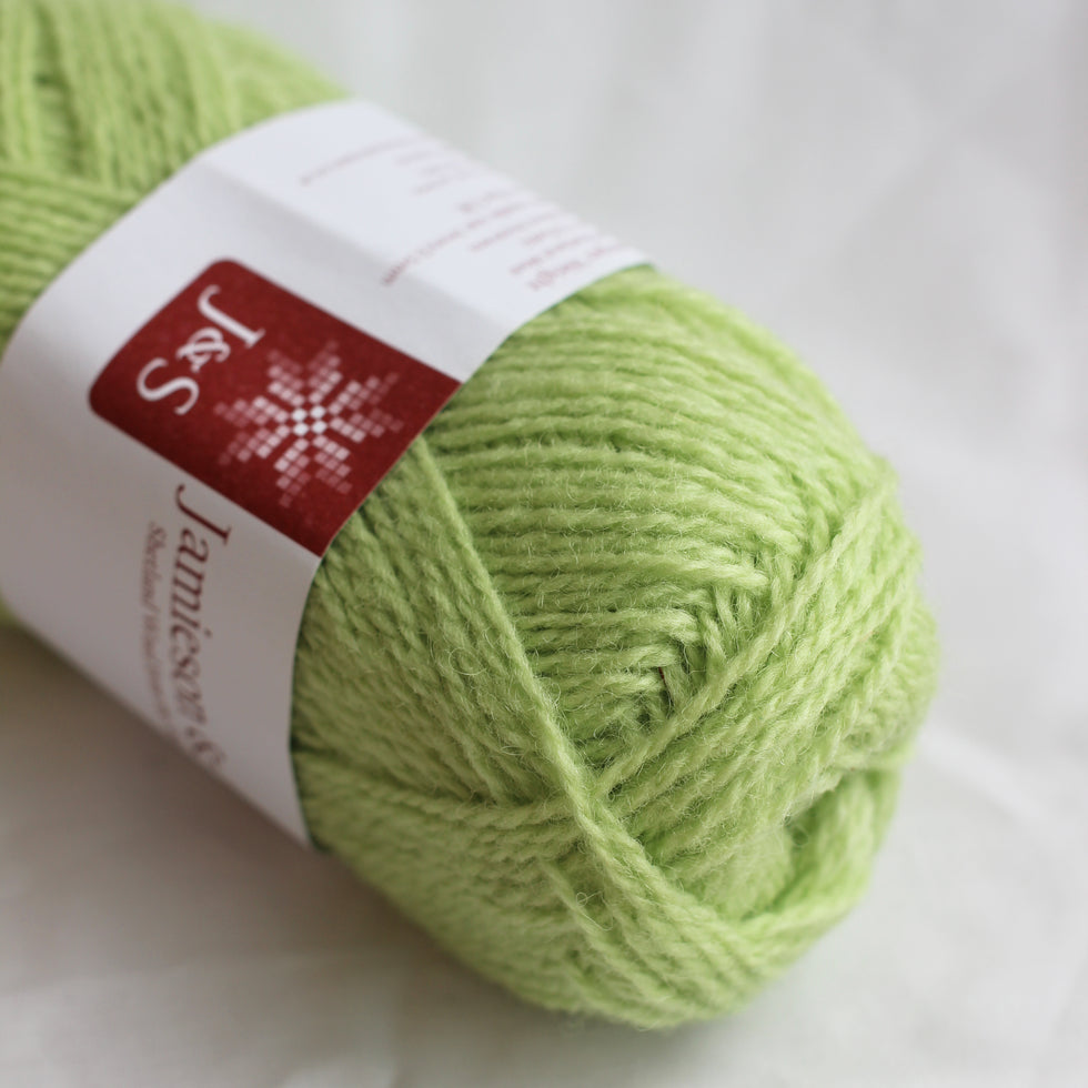Light green skein of yarn with a label on a white background
