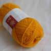 Yellow yarn ball with a label on a white background