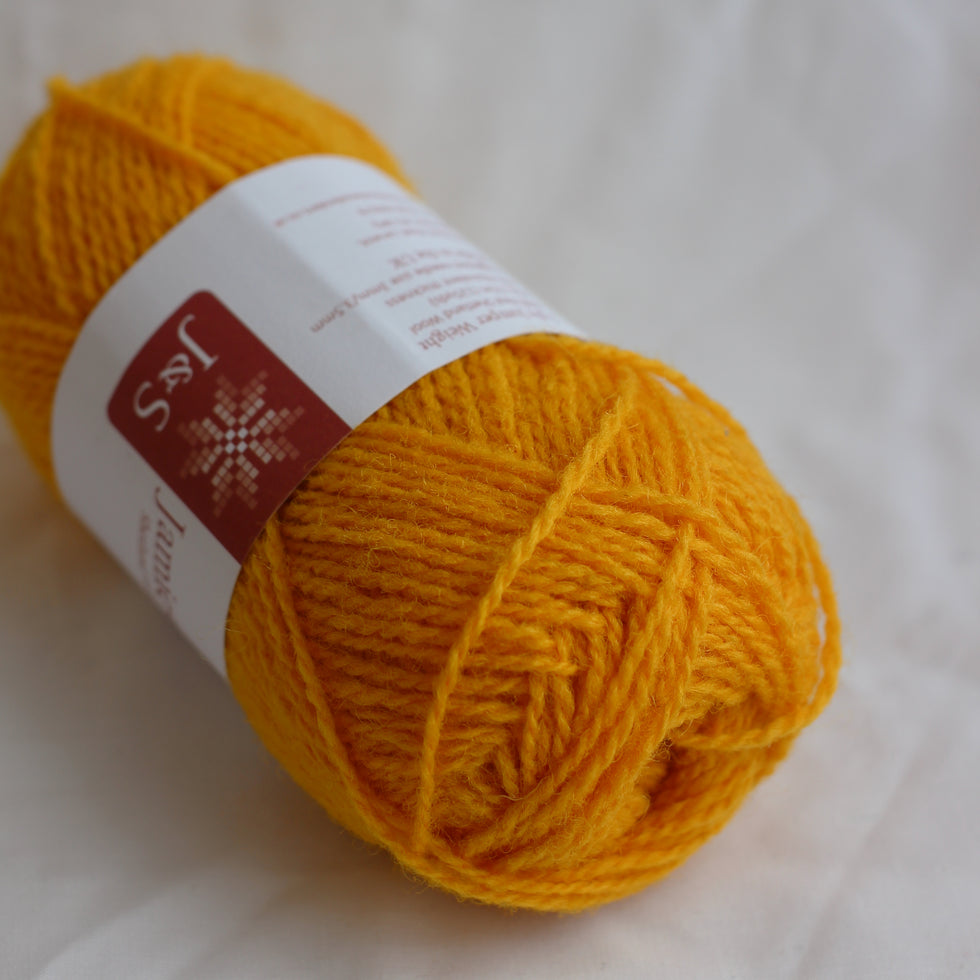 Yellow yarn ball with a label on a white background