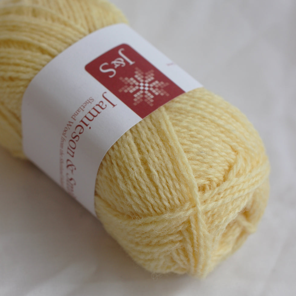 Yellow yarn ball with a label on a white background