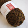 Brown yarn ball with a label on a white background
