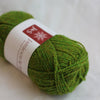 Green skein of yarn with a label on a white background
