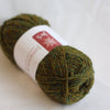 Green skein of yarn with a label on a white background