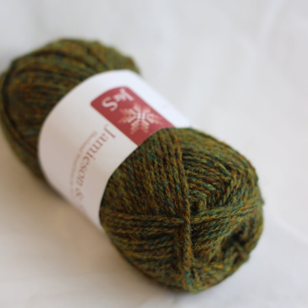 Green skein of yarn with a label on a white background