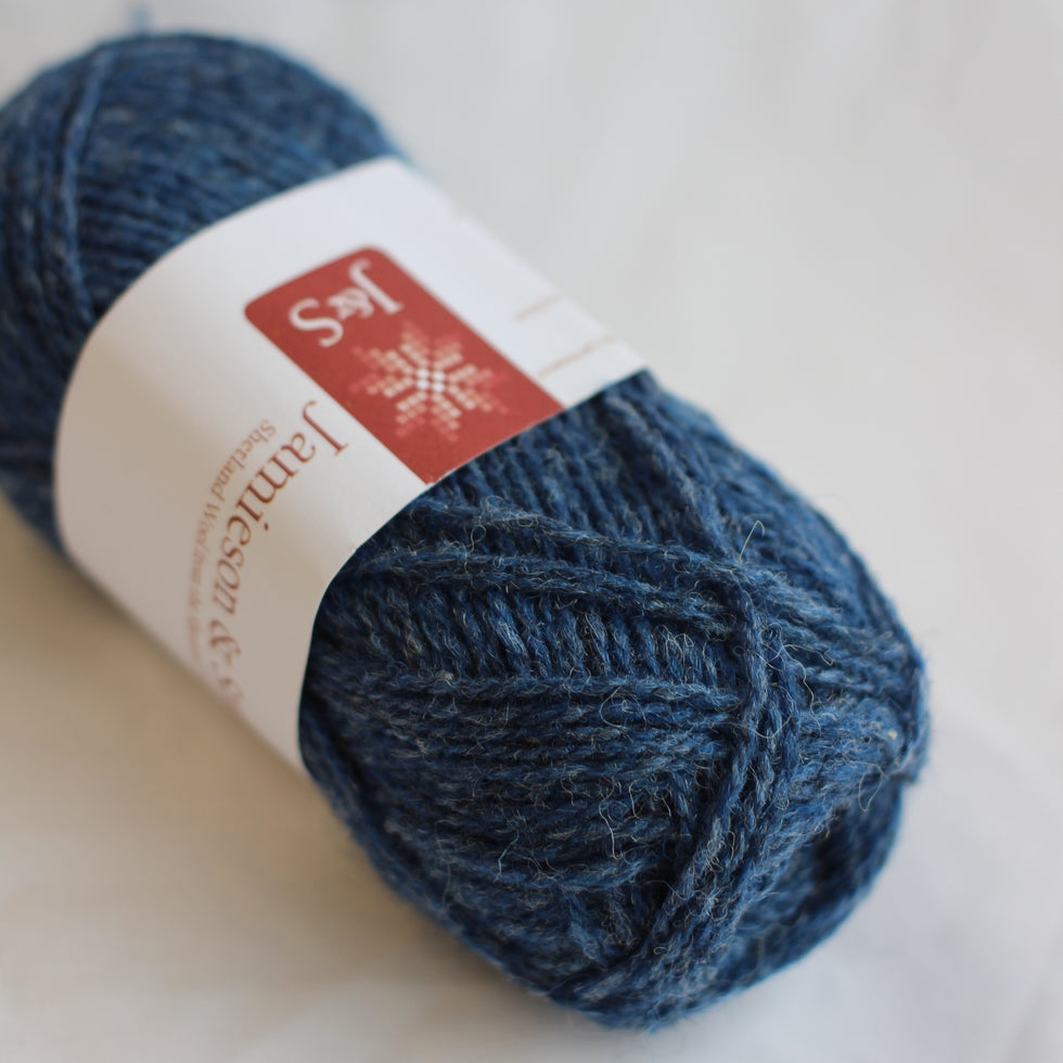 Blue yarn ball with a label on a light background