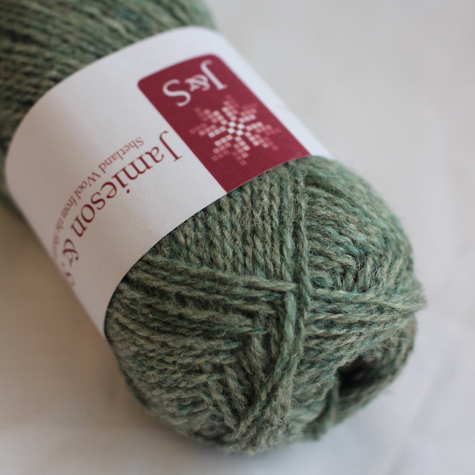 Green skein of yarn with a label on a white background