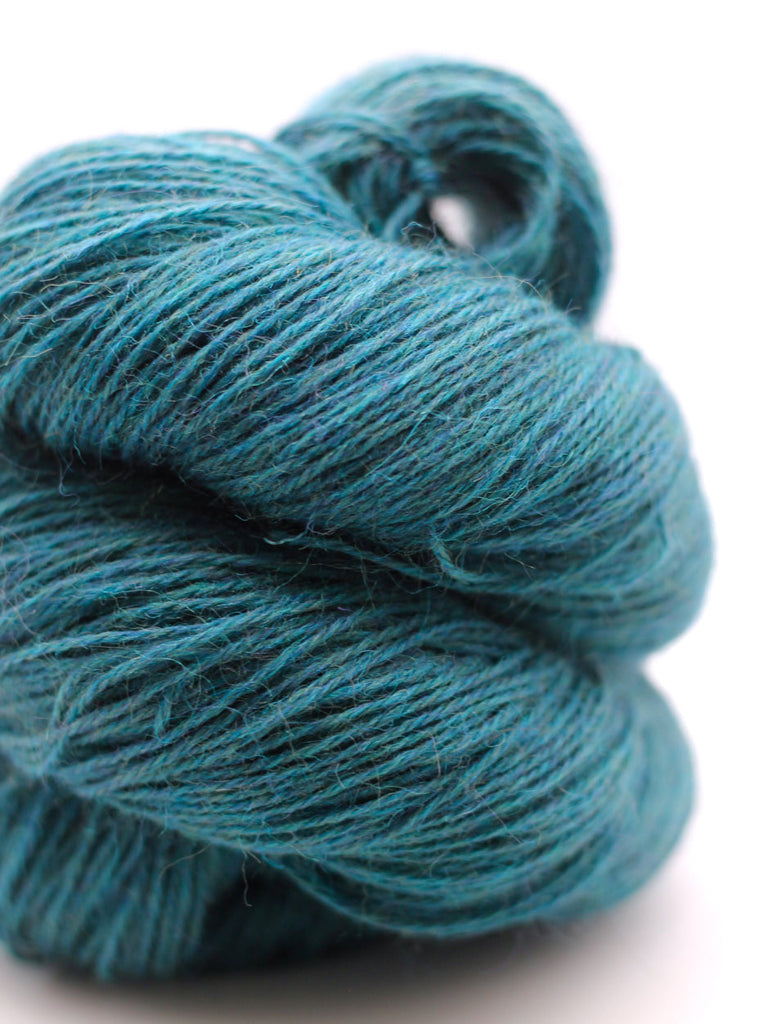 Teal skein of yarn on a white background
