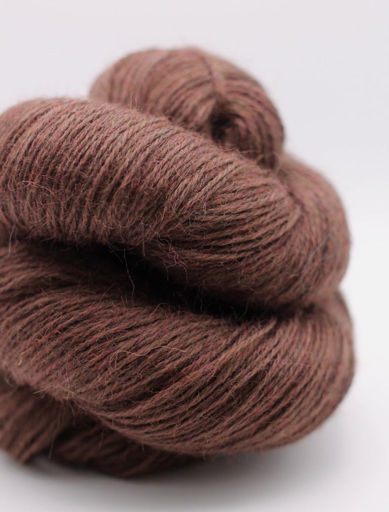 Brown skein of yarn on a white background