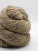 A close-up of a skein of textured yarn in a warm taupe-brown color, photographed on a clean white background.