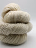 1 skein of soft, cream-colored yarn stacked together on a light gray background.