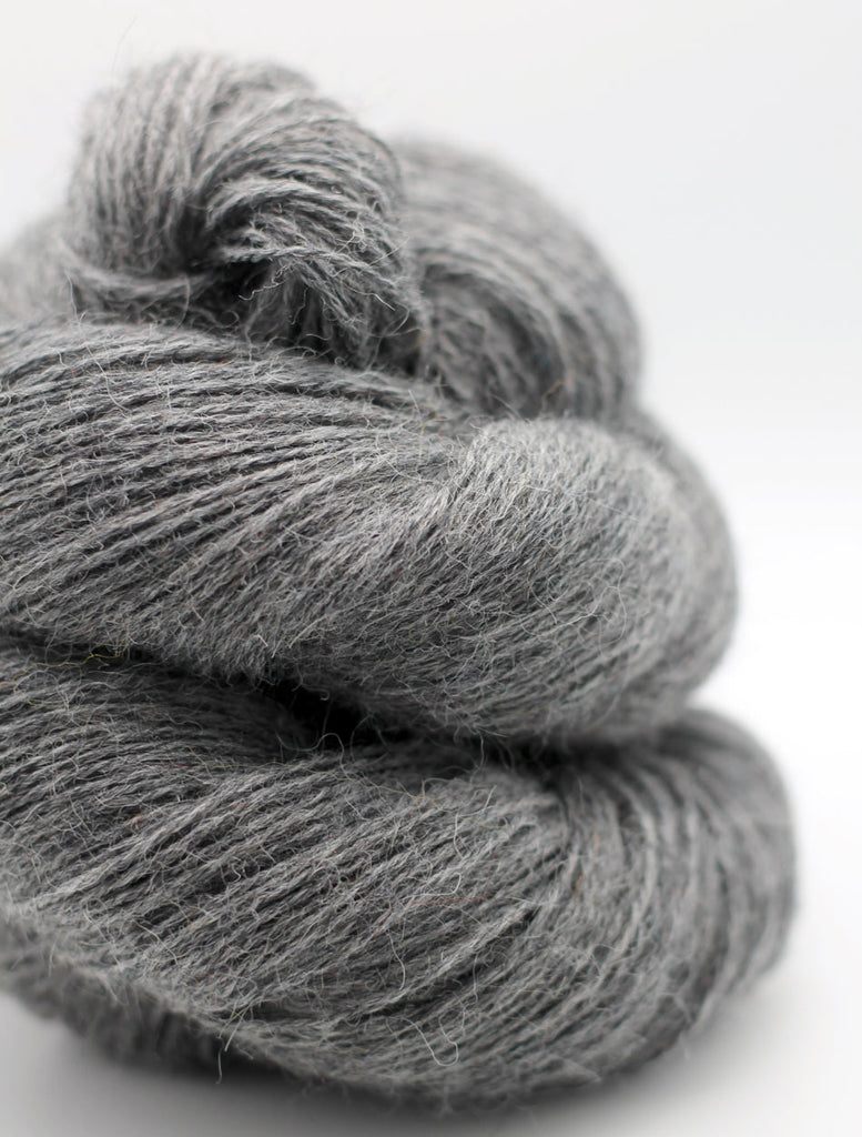 Gray skein of yarn on a white background