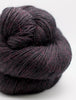 Dark purple skein of yarn on a white background