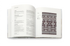Open book with text and a pattern on a white background