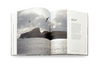 Open book showing a photograph of a landscape with mountains and water, accompanied by text on a white background.