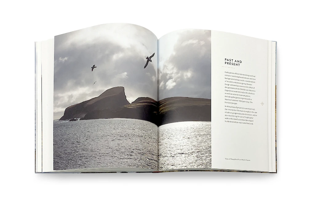 Open book showing a photograph of a landscape with mountains and water, accompanied by text on a white background.
