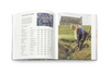 Open book showing a person working in a field with text on the left page.
