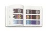 Open book displaying colorful geometric patterns on a white background