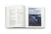 Open book with text on one page and a photograph of a lighthouse on the other, on a white background.