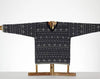 Black and white patterned sweater on a wooden mannequin against a white background