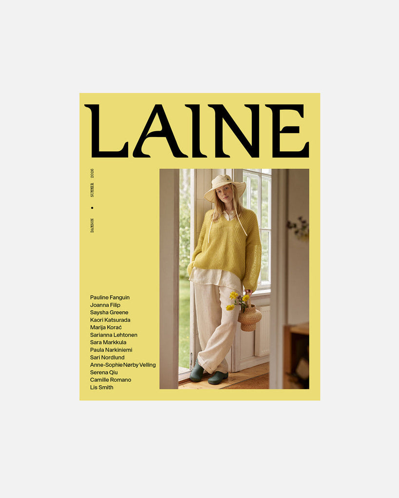 Magazine cover with a person in a yellow sweater and white pants, featuring the brand 'Laine'.