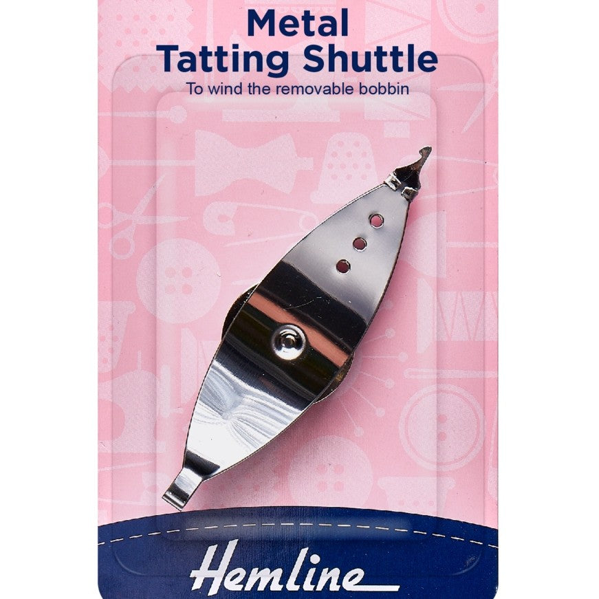 Metal tatting shuttle with 'Hemline' branding on a pink background
