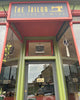  storefront with 'The Tailor Coffee & Wine' sign