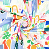 Colorful abstract patterned fabric with various shapes and colors.
