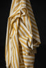 Yellow and white striped fabric on a black background