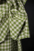Green and white checkered fabric on a black background