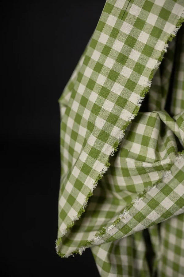 Close-up of green and white checkered fabric on a black background