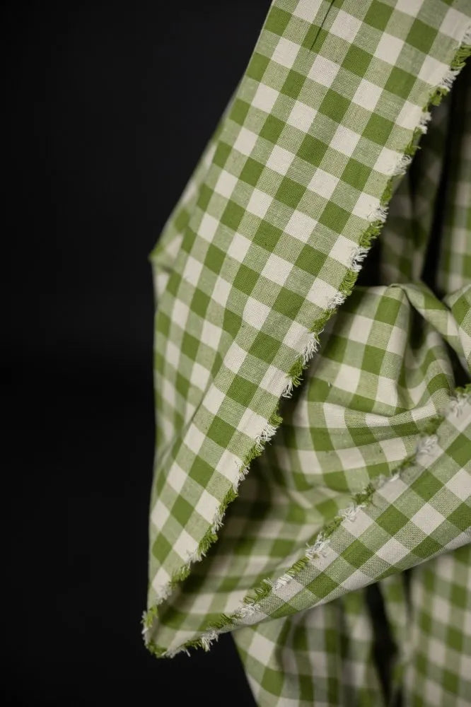 Close-up of green and white checkered fabric on a black background