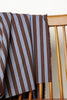 Brown and blue striped fabric draped over a wooden chair