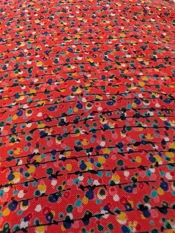 Multicolored abstract pattern on a red background