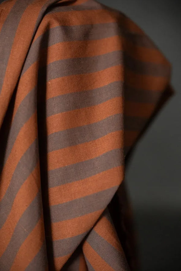 Close-up of brown and orange striped fabric against a dark background