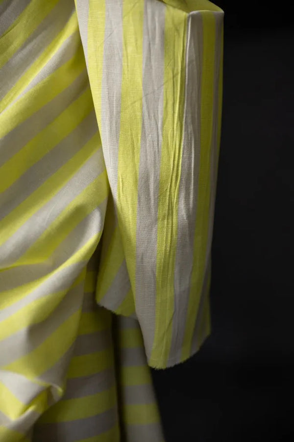 Close-up of yellow and white striped fabric against a black background