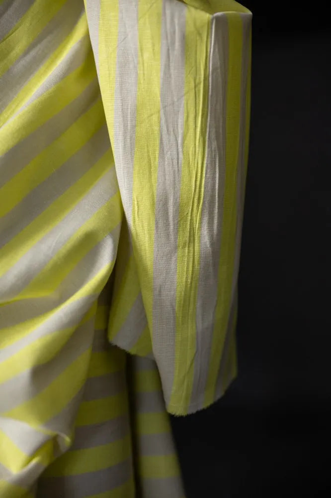 Close-up of yellow and white striped fabric against a black background