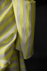 Close-up of yellow and white striped fabric against a black background