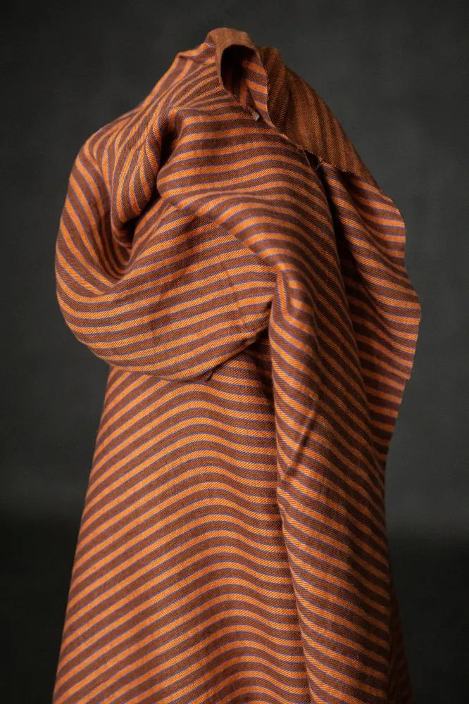Brown striped fabric draped over a black background